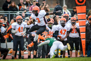 Reidgee Dimanche leaps over a Steinert tackler and takes off down the sidelines. Photo by Michael A. Sabo
